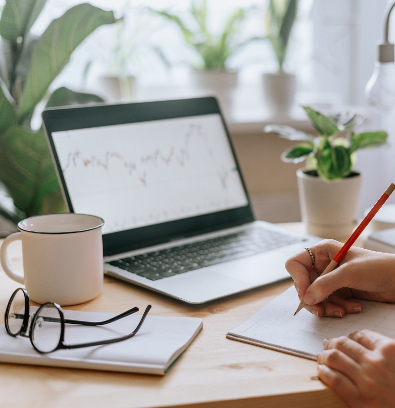 Woman holding pencil with laptop and coffee Woman holding pencil with laptop and coffee